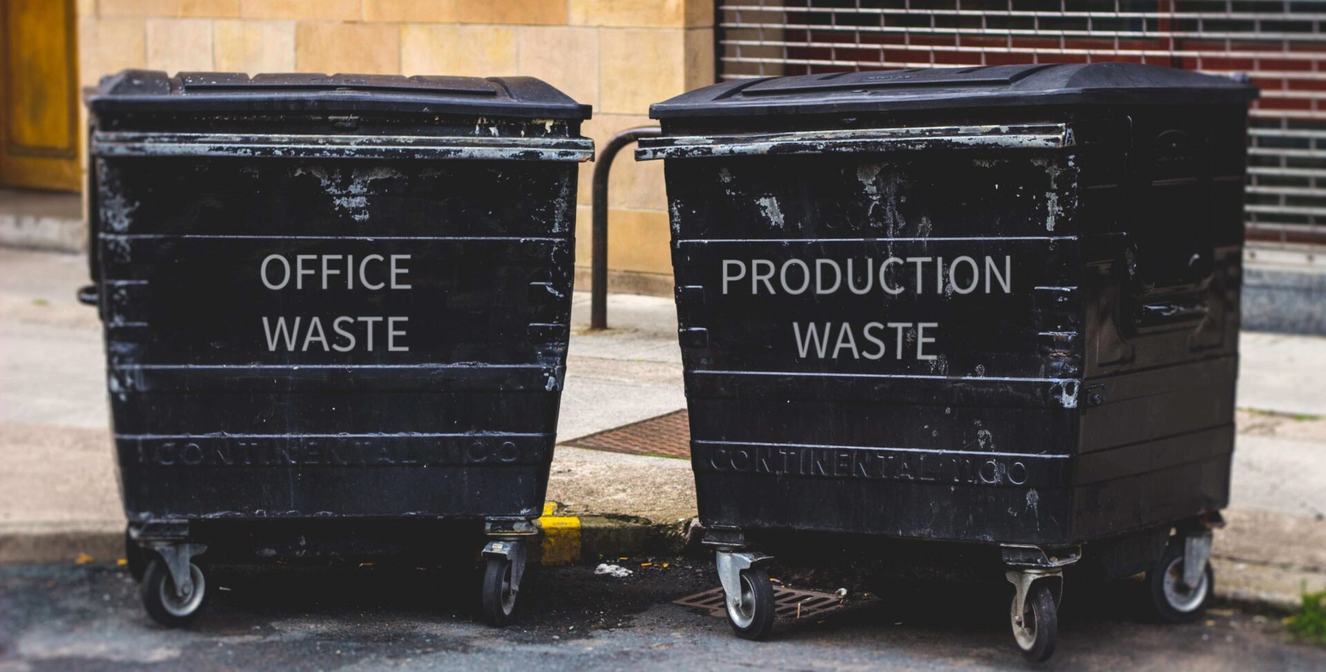 two large garbage cans on the first one is written OFFICE WASTE and on the second is written Production Waste